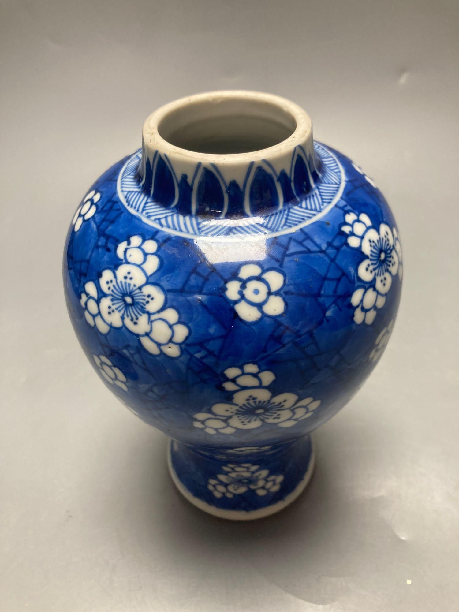A Chinese blue and white vase, Kangxi period, wood cover, neck reduced, 18cm